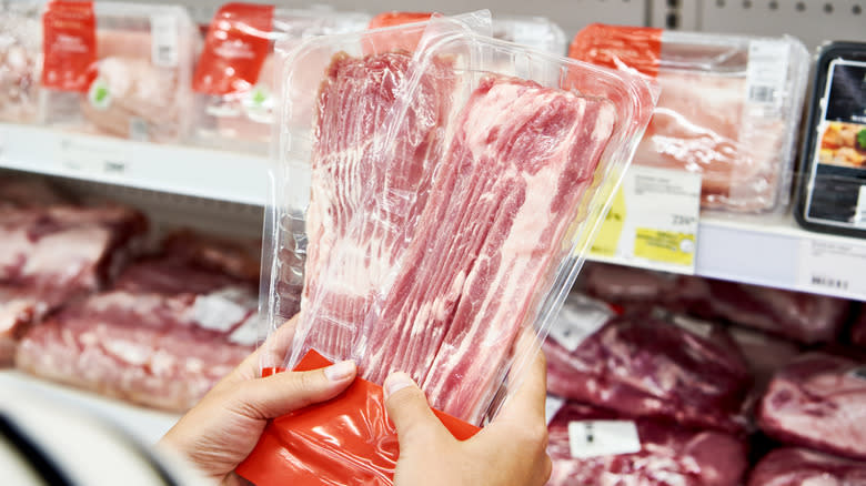 woman buying pork in the grocery store