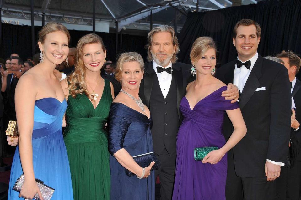 <p>The proud parents pose at the 2011 Oscars with (from left) daughters Hayley, Jessie and Isabelle and her husband, Brandon Boesch.</p>