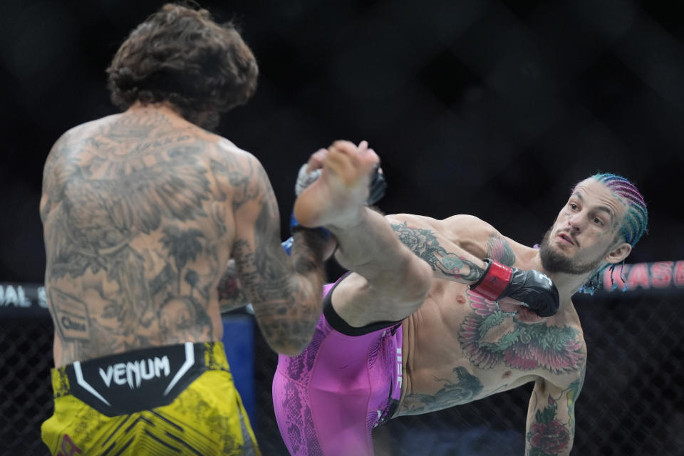 Sean O'Malley tries to kick Marlon Vera during a bantamweight title bout at the UFC 299 mixed martial arts event, early Sunday, March 10, 2024, in Miami. O'Malley retained his title. (AP Photo/Wilfredo Lee)