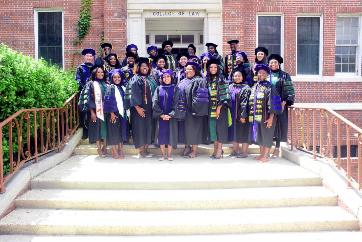 FAMU College of  Law Dean Deidré Keller and 2022 FAMU Law graduates outside of the original College of Law building on the campus of Florida A&M University.