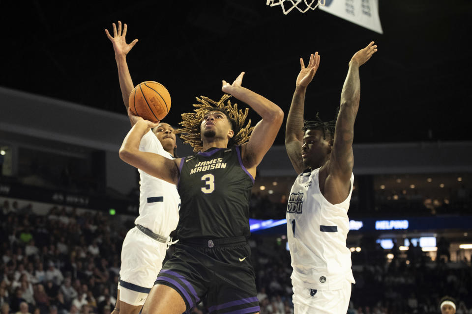 James Madison forward T.J. Bickerstaff (3) drives in for a layup against Old Dominion guard Chaunce Jenkins (2) and forward Dani Pounds (11) during the first half of an NCAA college basketball game Saturday, Dec. 9, 2023, in Norfolk, Va. (AP Photo/Mike Caudill)