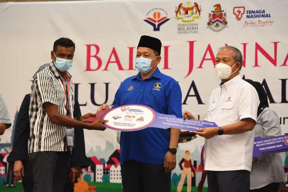 Another happy recipient of his home. — Picture courtesy of Tenaga Nasional Berhad