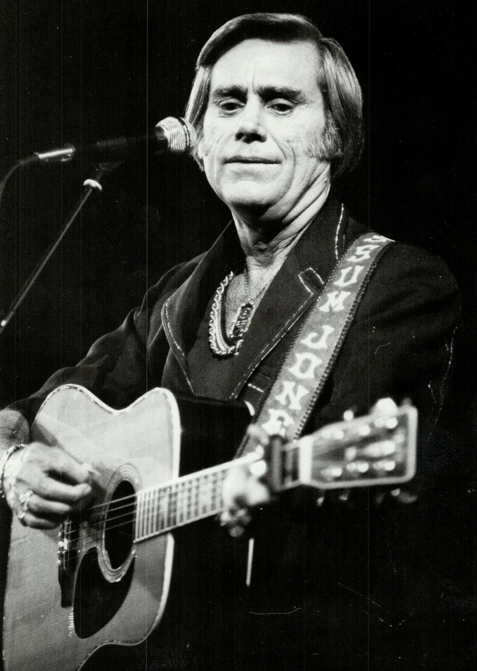 close up of singer george jones playing guitar at a concert