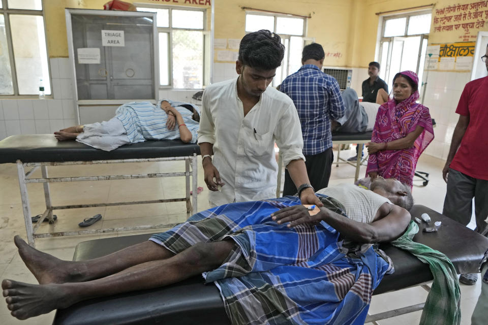 A medical assistant attends to a patient at the district hospital in Ballia, Uttar Pradesh state, India, Monday, June 19, 2023. Several people have died in two of India's most populous states in recent days amid a searing heat wave, as hospitals find themselves overwhelmed with patients. More than hundred people in the Uttar Pradesh state, and dozens in neighboring Bihar state have died due to heat-related illness. (AP Photo/Rajesh Kumar Singh)