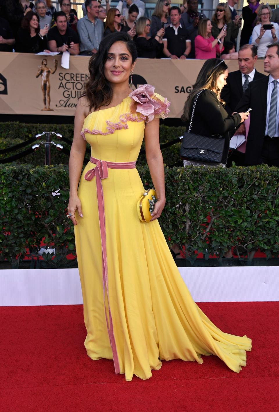 <p>One look at Salma Hayek’s yellow and pink dress is sure to put a smile on even the Grinch’s face. (Photo: Getty Images) </p>