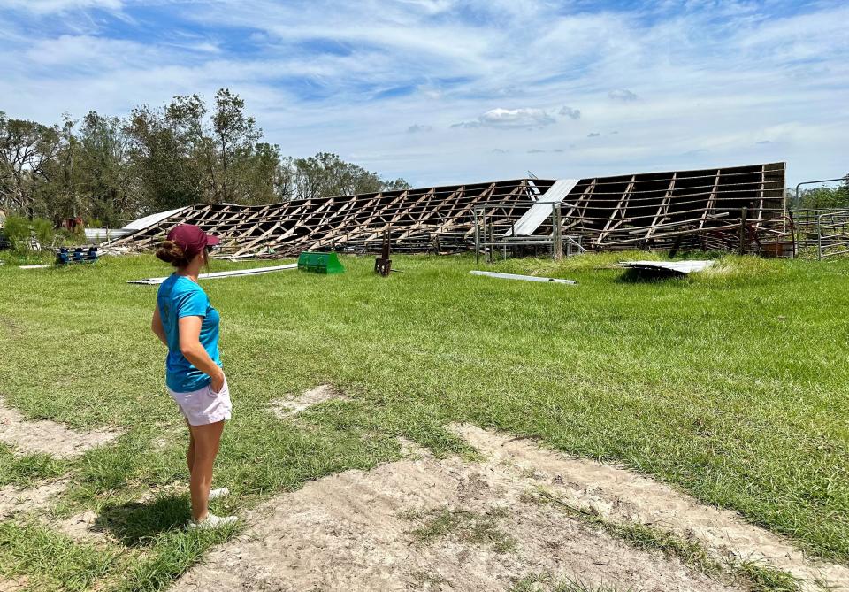 Tori Lyons tours the damage at Lyons Show Pigs in Lafayette County, Florida, on Tuesday, Sept. 5, 2023. The hurricane wrecked barns and other structures on the 100-acre property.