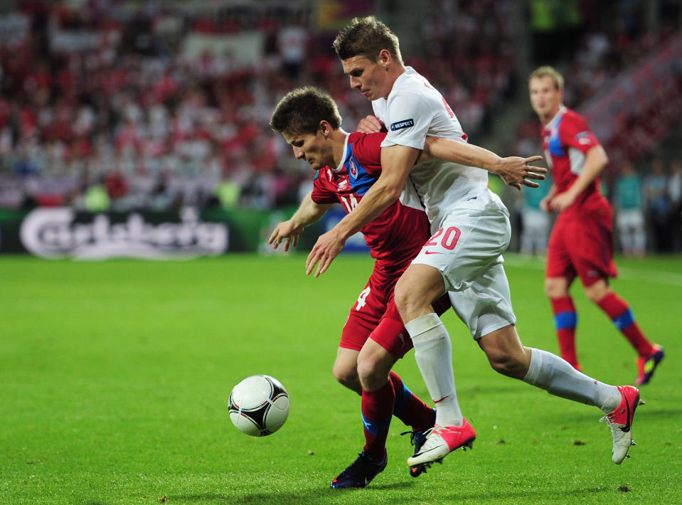 WROCLAW, POLAND - JUNE 16: Lukasz Piszczek of Poland and Vaclav Pilar of Czech Republic compete for the ball during the UEFA EURO 2012 group A match between Czech Republic and Poland at The Municipal Stadium on June 16, 2012 in Wroclaw, Poland. (Photo by Jamie McDonald/Getty Images)