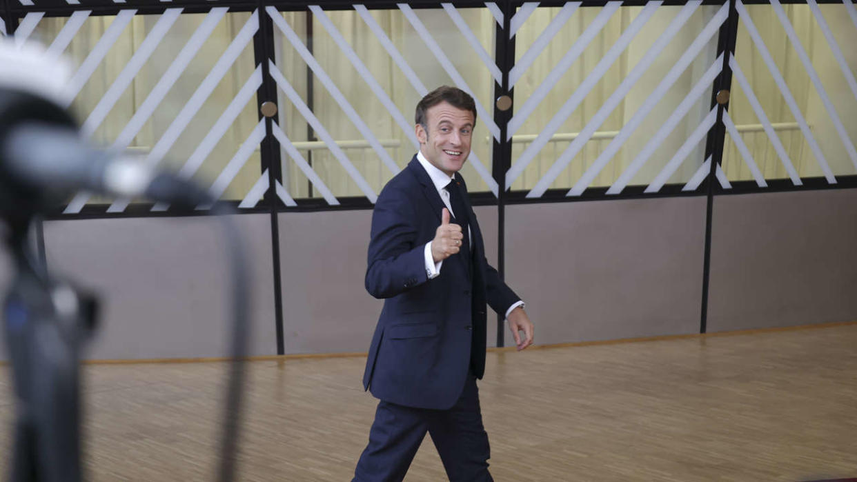 Emmanuel Macron President of the Republic of France arrives at the European Council summit and does a hand gesture to the media while smiling. The European council meeting of the EU leaders. Brussels, Belgium on 20 October 2022.  (Photo by Nicolas Economou/NurPhoto via Getty Images)