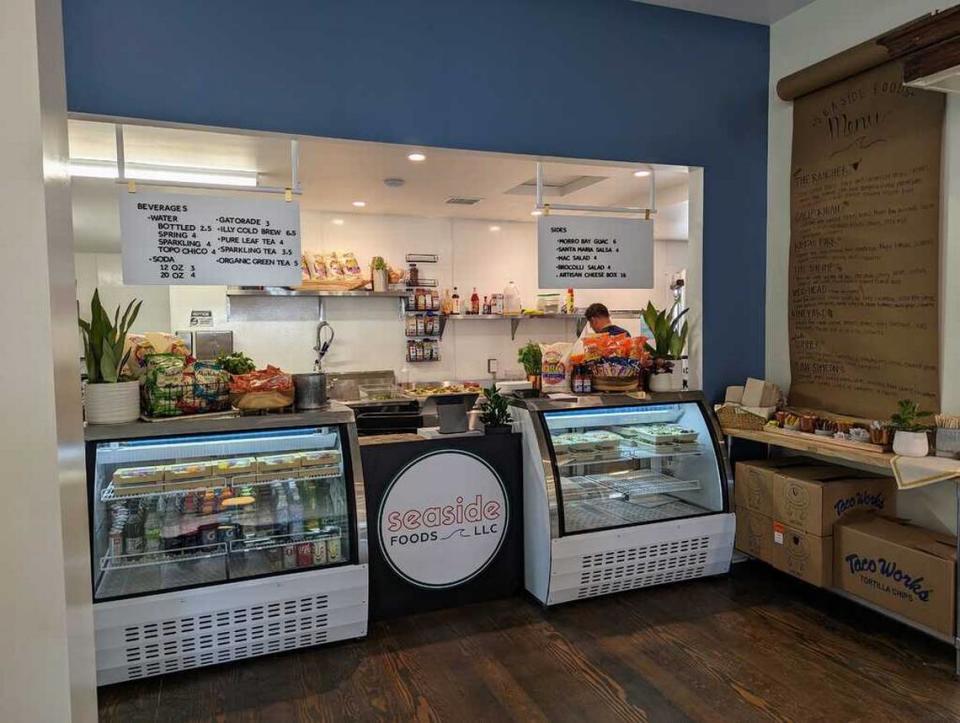 Chef/business owner Alex Labastida works behind the deli display case on reopening day, June 16, 2023, at his Seaside Foods in the completely renovated Sebastian’s General Store in Old San Simeon Village. Henry Krczuik