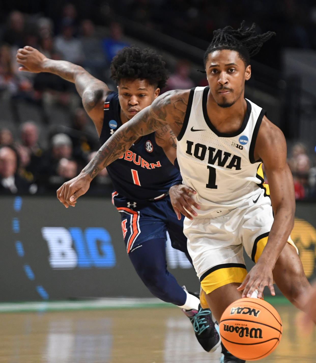 Mar 16, 2023; Birmingham, AL, USA; Auburn guard Wendell Green Jr. (1) defends a drive by Iowa guard Ahron Ulis (1) during the NCAA regional. at Legacy Arena. Mandatory Credit: Gary Cosby Jr.-Tuscaloosa News