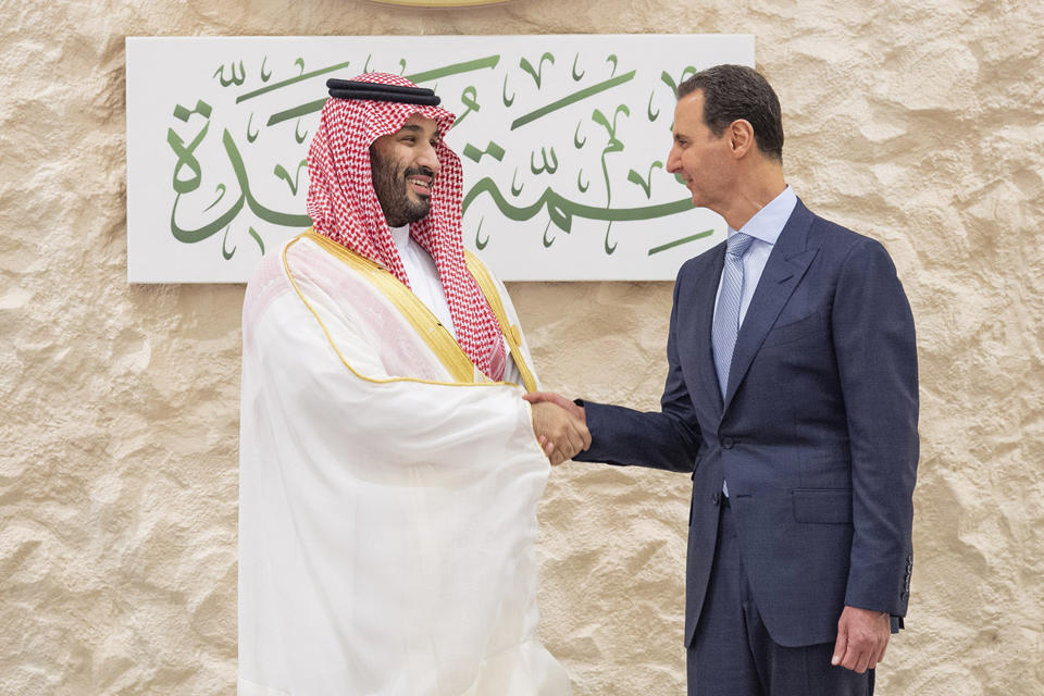 In this photo provided by Saudi Press Agency, SPA, Saudi Crown Prince Mohammed bin Salman, left, greets Syrian President Bashar Assad during the Arab summit in Jeddah, Saudi Arabia, Friday, May 19, 2023. (Saudi Press Agency via AP)