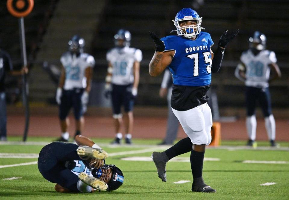 Madera’s Issaiah Beas, right, motions with upraised hands after he sacked Bullard quarterback Jerren Mao, left, in a CMAC game Friday, Sept. 29, 2023 in Madera.