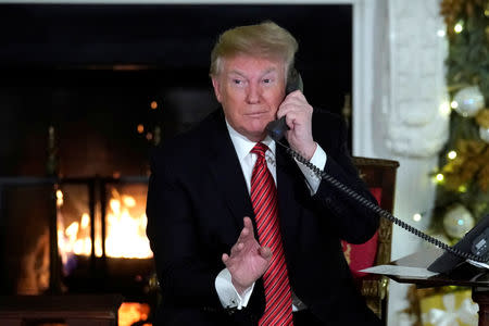 U.S. President Donald Trump participates in NORAD Santa tracker phone calls from the White House in Washington, U.S. December 24, 2018. REUTERS/Jonathan Ernst