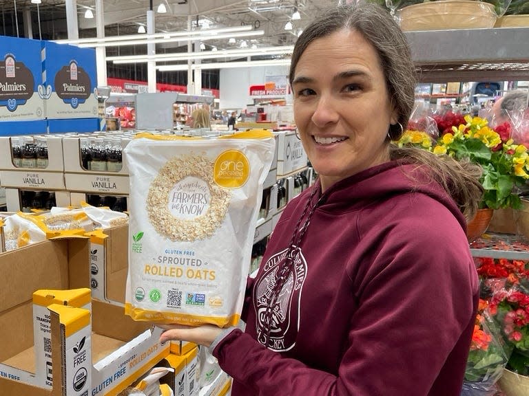 Hilary holding a bag of gluten-free sprouted rolled oats.