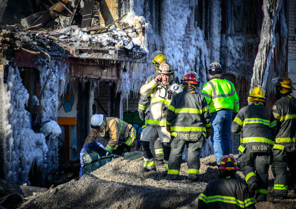 Investigators discover a body of a fire victim, Thursday, Jan. 2, 2014 in Minneapolis. Authorities said Thursday they have discovered a body in the ruins of a Minneapolis apartment fire, as investigators were honing in on natural gas as a potential cause of the explosion and blaze that left 14 other people injured. (AP Photo/The Star Tribune, Glen Stubbe) MANDATORY CREDIT; ST. PAUL PIONEER PRESS OUT; MAGS OUT; TWIN CITIES TV OUT