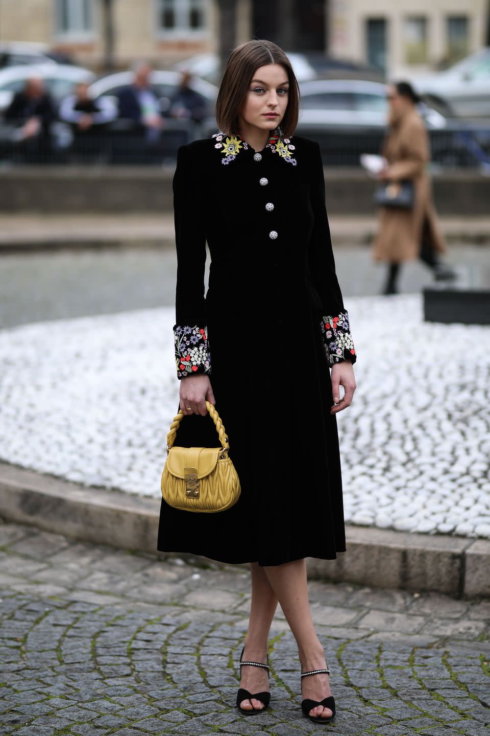 <p><strong>Wearing:</strong> A Miu Miu dress with an embroidered collar and cuffs, accessorised with a yellow bag also by the brand.</p><p><strong>Where: </strong>The Miu Miu autumn/winter 2020-21 show in Paris, March 2020.</p>