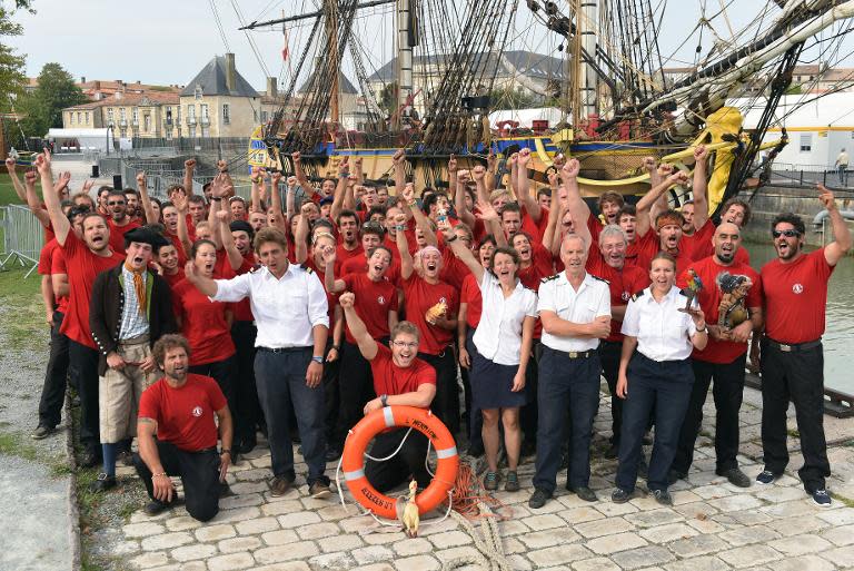 Crew members of the replica of the Hermione posing for a family photo in front of their ship on in Rochefort, western France, September 6, 2014