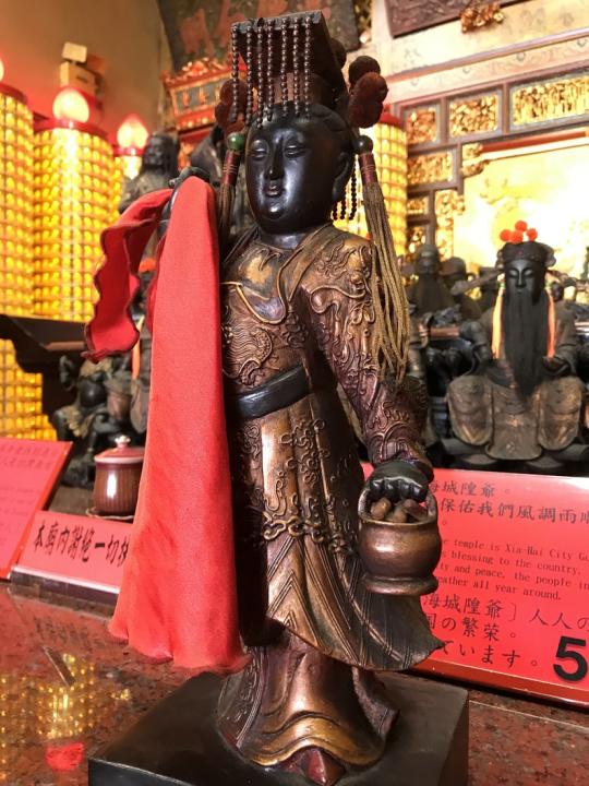 嫘祖右手拿著一塊紅色的布，象徵發明蠶絲織衣。圖/台北霞海城隍廟提供。
