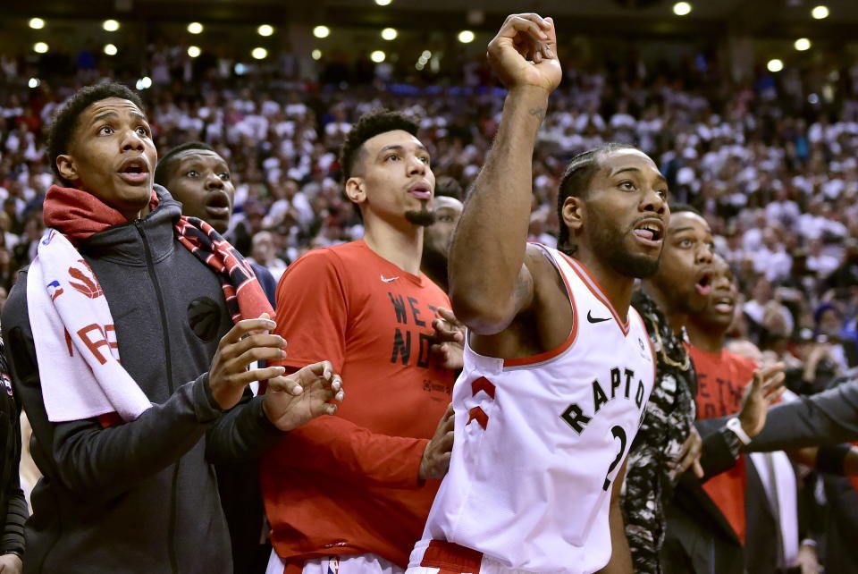 Toronto Raptors forward Kawhi Leonard (2) and teammates watch as the ball bounces around the rim as time begins to expire in an NBA Eastern Conference semifinal basketball game, in Toronto, Sunday, May 12, 2019. Leonard hit the game-winning basket as time expired, and the Toronto Raptors advanced to the Eastern Conference Final by beating the Philadelphia 76ers 92-90. (Frank Gunn/The Canadian Press via AP)