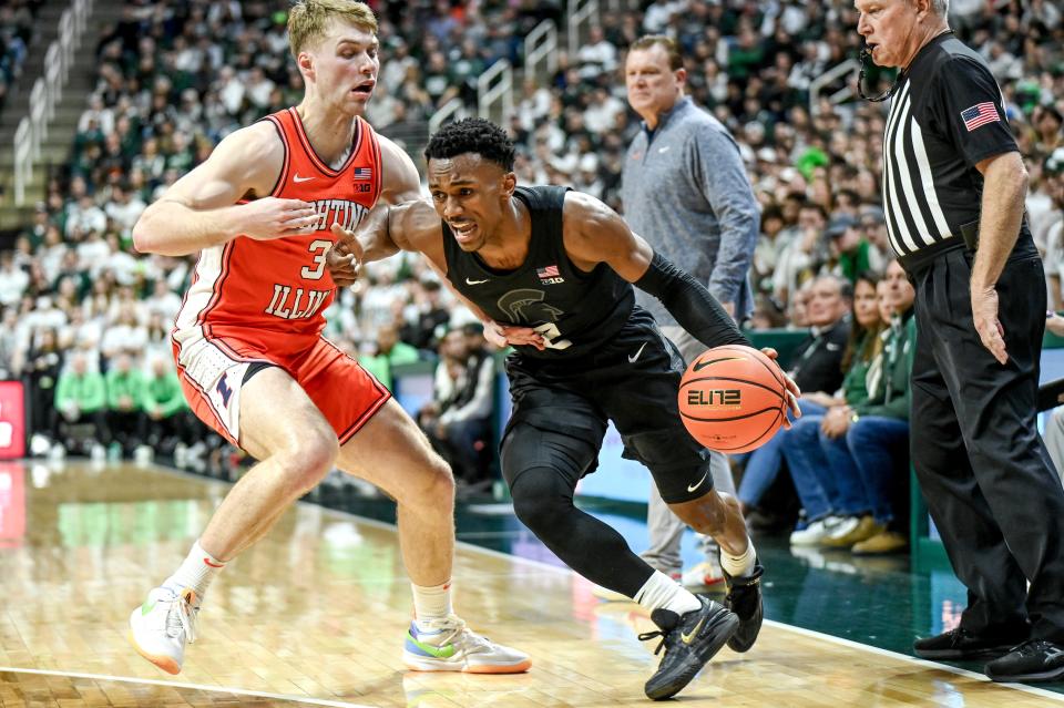 Michigan State's Tyson Walker, right, moves the ball as Illinois' Marcus Domask defends during the first half on Saturday, Feb. 10, 2024, at the Breslin Center in East Lansing.