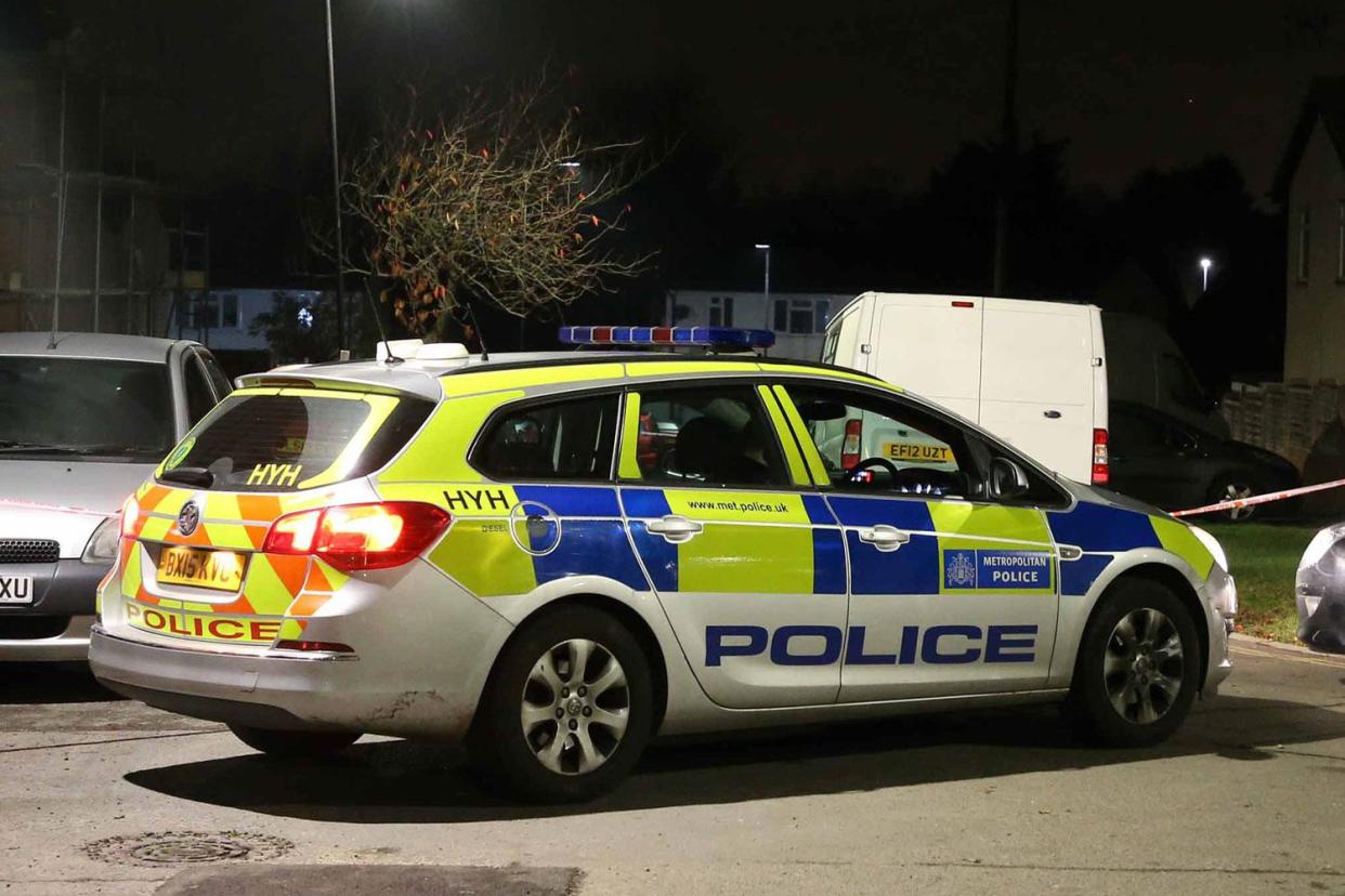 Police at the scene of the stabbing in Northolt: Nigel Howard