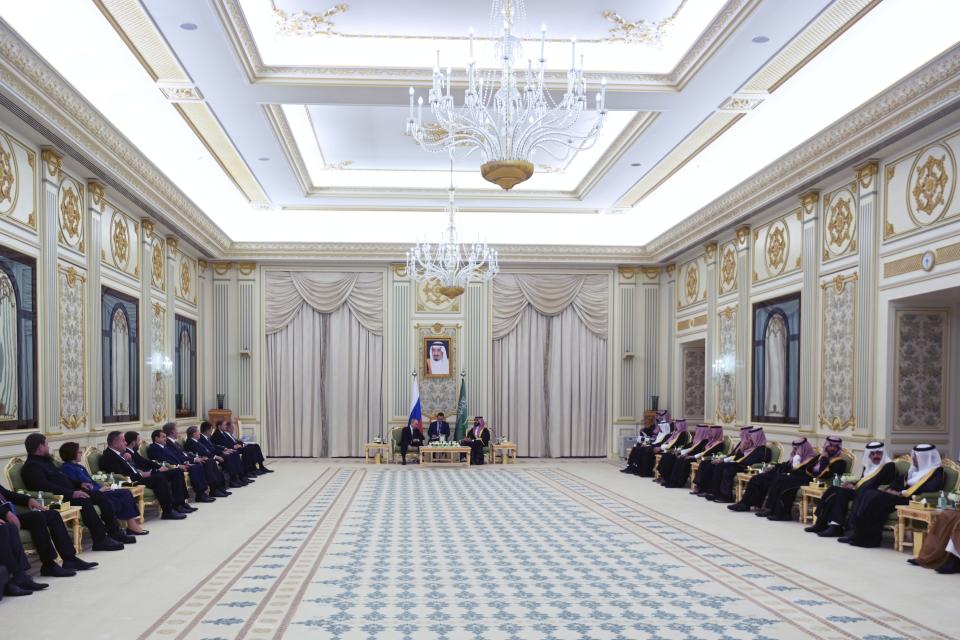 Saudi Crown Prince Mohammed bin Salman welcomes Russian President Vladimir Putin for the talks at the Al Yamamah Palace in Riyadh, Saudi Arabia, on Wednesday, Dec. 6, 2023. A picture showing Saudi King Salman is in the center. (Alexei Nikolsky, Sputnik, Kremlin Pool Photo via AP)