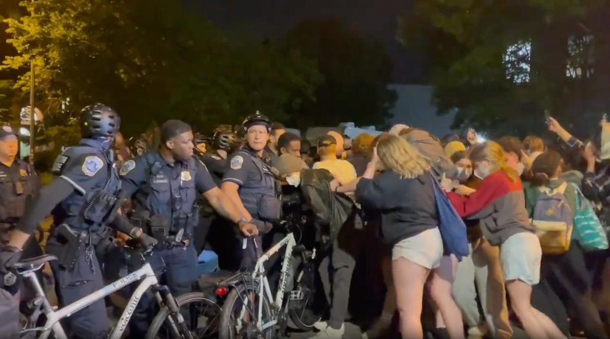 PHOTO: A screengrab from a video posted on X shows student protestors from George Washington University clashing with police in Washington, DC, May 8, 2024. (Joy Wang/ABC7)