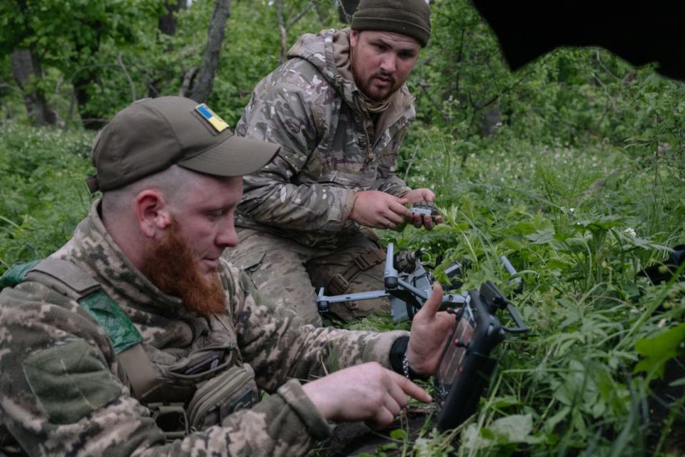 A Ukrainian drone team sets up a drone for dropping munitions at positions north of Chasiv Yar, Donetsk Oblast, on April 24, 2024. (Francis Farrell/The Kyiv Independent)