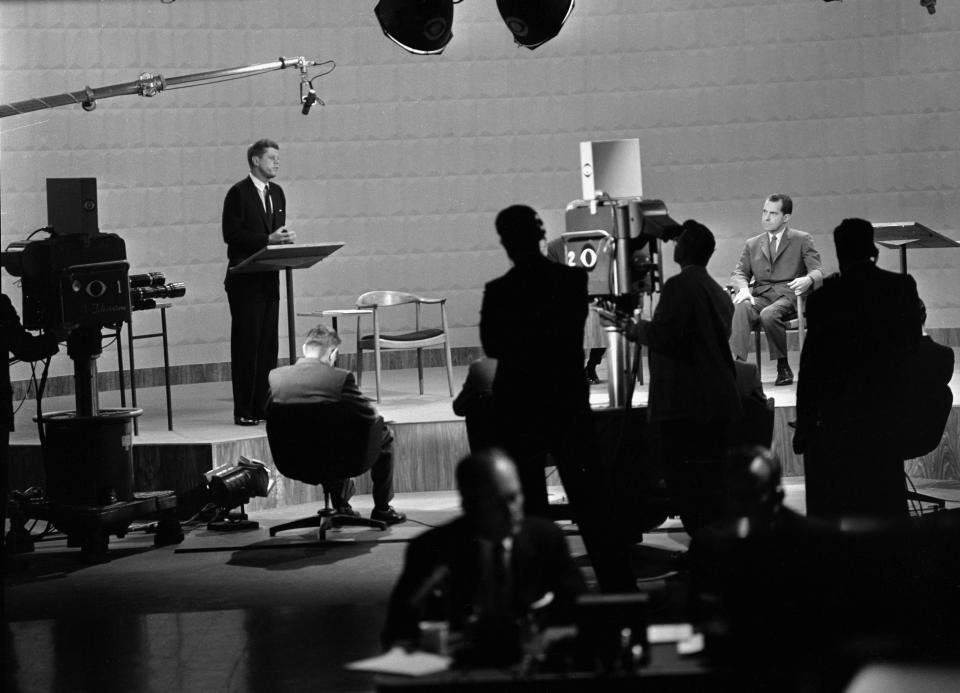 John F. Kennedy, left, speaks during the debate with Richard M. Nixon, seated on September 26, 1960 in Chicago.  (CBS via Getty Images)