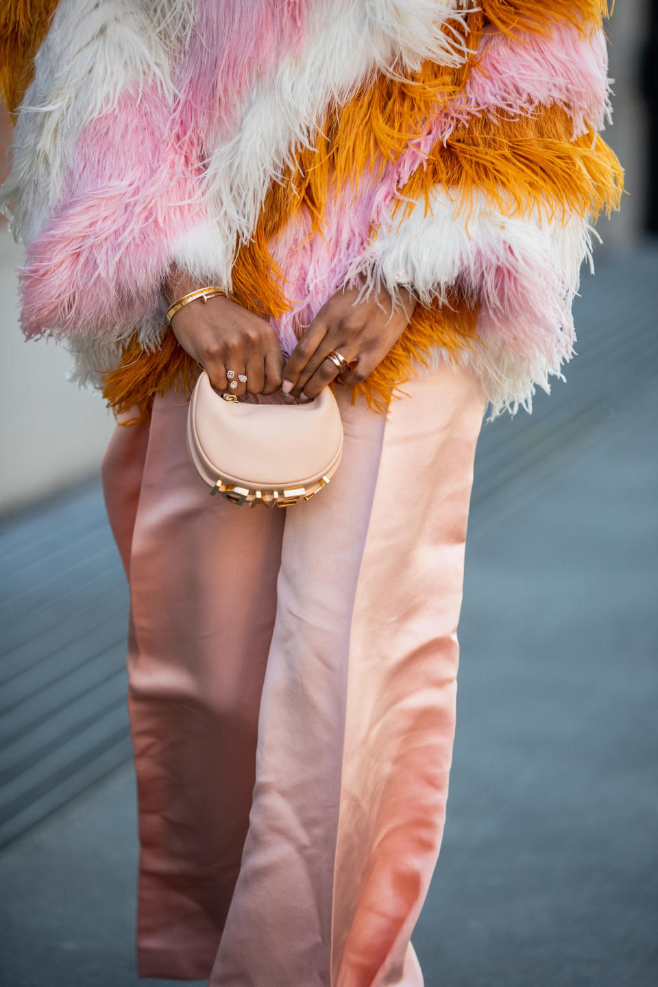 MILAN, ITALY - FEBRUARY 23: Didi Stone seen wearing striped rose, orange, white fur jacket, micro bag, wide leg pink bag, heels outside of Fendi fashion show during the Milan Fashion Week Fall/Winter 2022/2023 on February 23, 2022 in Milan, Italy. (Photo by Christian Vierig/Getty Images)