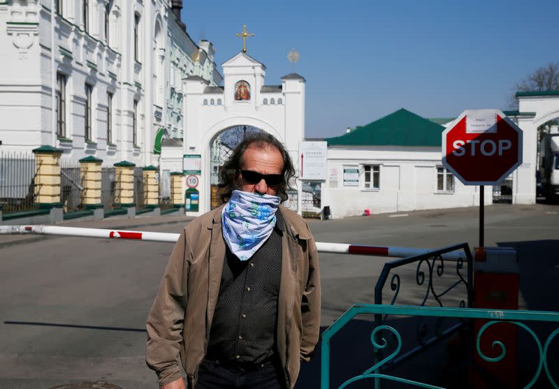 FILE PHOTO: A man walks in front of the gate of the Kiev Pechersk Lavra monastery in Kiev