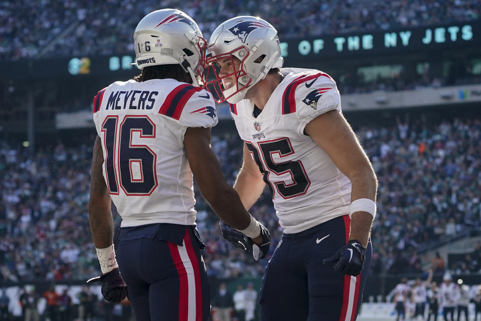 New England Patriots tight end Hunter Henry (85) celebrates with wide receiver Jakobi Meyers (16) after Meyers scored a touchdown against the New York Jets during the third quarter of an NFL football game, Sunday, Oct. 30, 2022, in New York. (AP Photo/John Minchillo)