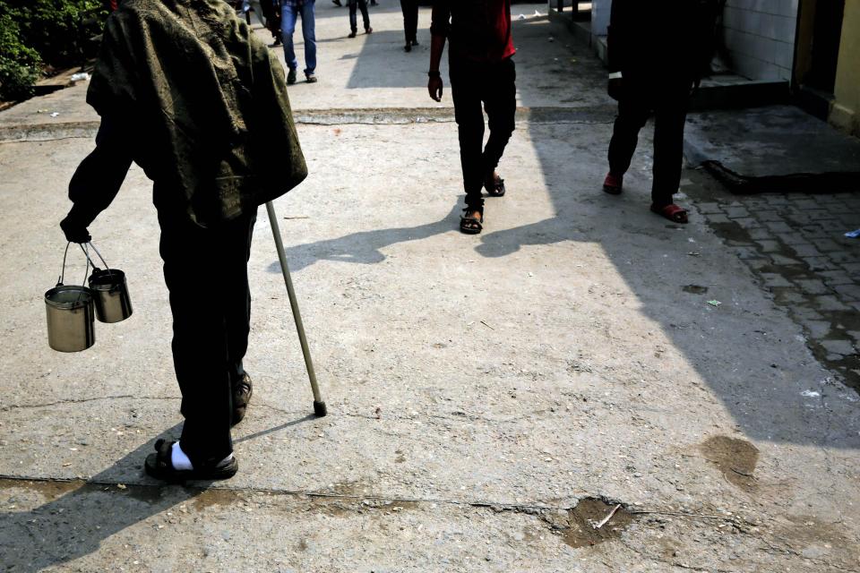 In this Feb. 16, 2014 photo, an Indian man suffering from Leprosy walks homeward after collecting food from a charitable organization at a leper colony in New Delhi, India. Although India has made great strides against leprosy over the years, the stigma of the disease is as intractable as ever, hindering efforts to eliminate the disease entirely. Worldwide the number of new leprosy patients has dropped from around 10 million in 1991 to around 230,000 last year. Of these, 58 percent were to be found in India, according to the World Health Organization. (AP Photo/Manish Swarup)