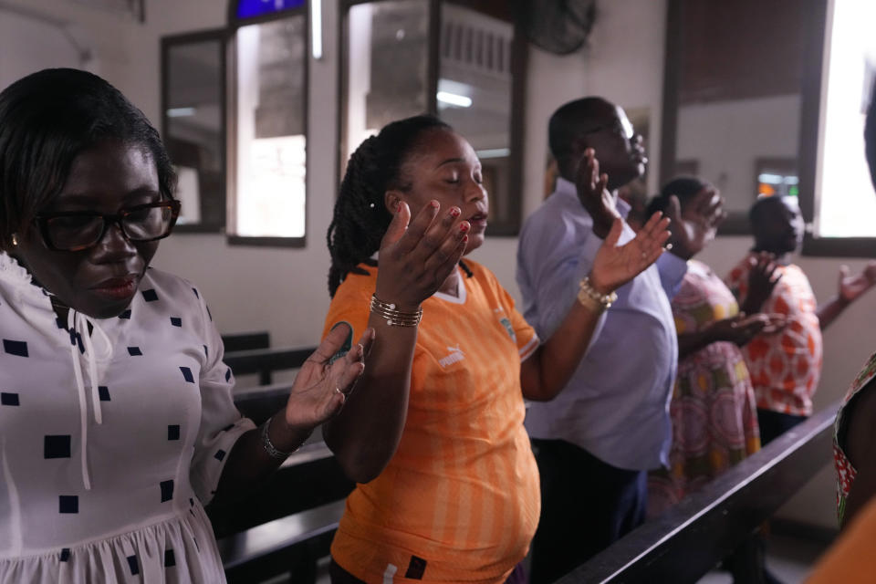 Catholic faithful pray at the Chapelle de l'Externat Saint Paul Church in Abidjan, Ivory Coast, Wednesday, Feb. 7, 2024. Ivory Coast's seemingly miraculous progression to the Africa Cup of Nations semifinals has convinced locals that God is on their side. The host nation has survived several close shaves with elimination thanks to fortune with results in other games and scarcely believable comebacks. (AP Photo/Sunday Alamba)