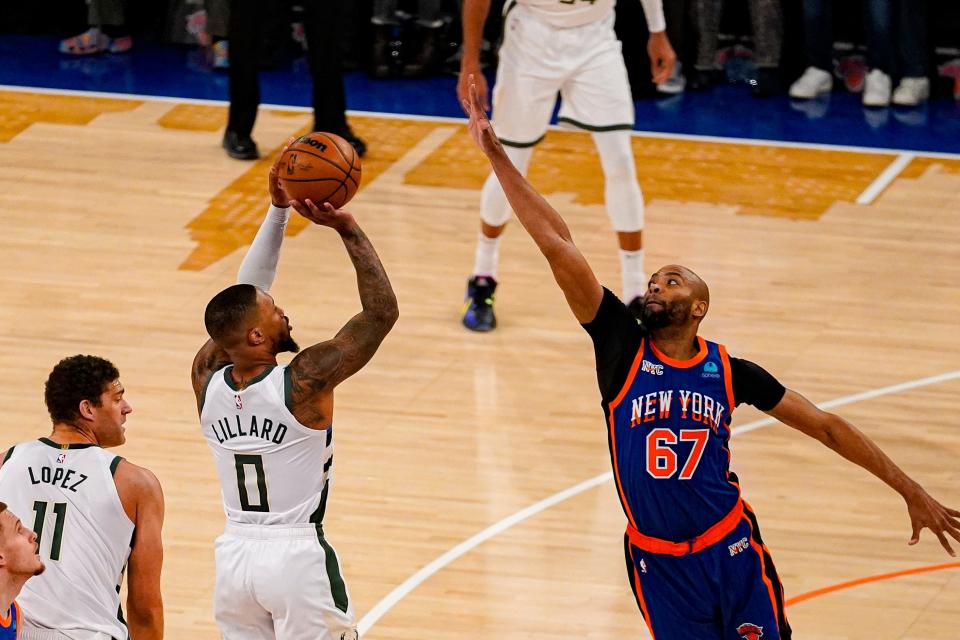 Bucks guard Damian Lillard shoots over Knicks forward Taj Gibson during the first half Saturday at Madison Square Garden.