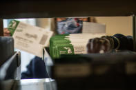 Election worker Mary Pluszczynsky files returned absentee ballots ahead of Tuesday's general election at the city clerk office in Warren, Mich., Wednesday, Oct. 28, 2020. (AP Photo/David Goldman)