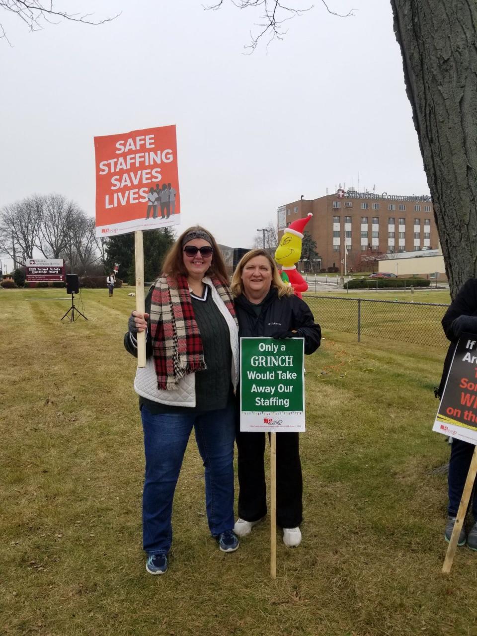 Registered nurses Shirley Crowell (left) and Anna Carlin, who are striking at Lower Bucks Hospital, join a picket line with other nurses at Suburban Community Hospital in East Norriton Tuesday before a pep rally was held by those on strike against both hospitals.  Crowell and Carlin are members of the Nurses Association of Lower Bucks Hospital and the Pennsylvania Association of Staff Nurses and Allied Professionals (PASNAP).