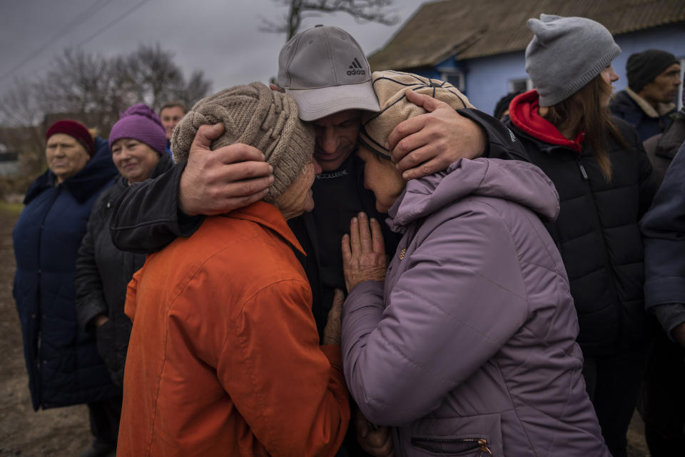 In the village of Tsentralne, Ukrainian family members meet for the first time since Russian troops withdrew from the Kherson region, southern Ukraine, Sunday, Nov. 13, 2022. Families were torn apart when Russia invaded in February, as some fled and others hunkered down. Now many are seeing one another for the first time in months, after Moscow's latest retreat amid a Ukrainian counteroffensive that has retaken a pocket of territory wedged between the regional capitals of Kherson and Mykolaiv and the Black Sea. (AP Photo/Bernat Armangue)