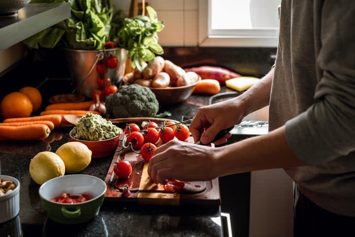 <span class="article__caption">Shot of a vegan meal preparation with lots of vegetables and fruits on a domestic kitchen</span>
