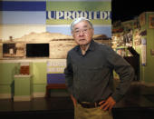 In this photo taken Tuesday, Feb. 11, 2020, Les Ouchida poses at the permanent exhibit titled "UpRooted Japanese Americans in World War II" at the California Museum in Sacramento, Calif. Ochida, who is a docent for the exhibit, was a child when his family was forced to move in 1942 from their home near Sacramento to an internment camp in Arkansas. Assemblyman Al Muratsuchi, D-Torrence has introduced a resolution to apologize for the state's role in carrying out the federal government's internment of Japanese-Americans. A similar resolution will be brought up before the state Senate by Sen. Richard Pan, D-Sacramento. (AP Photo/Rich Pedroncelli)