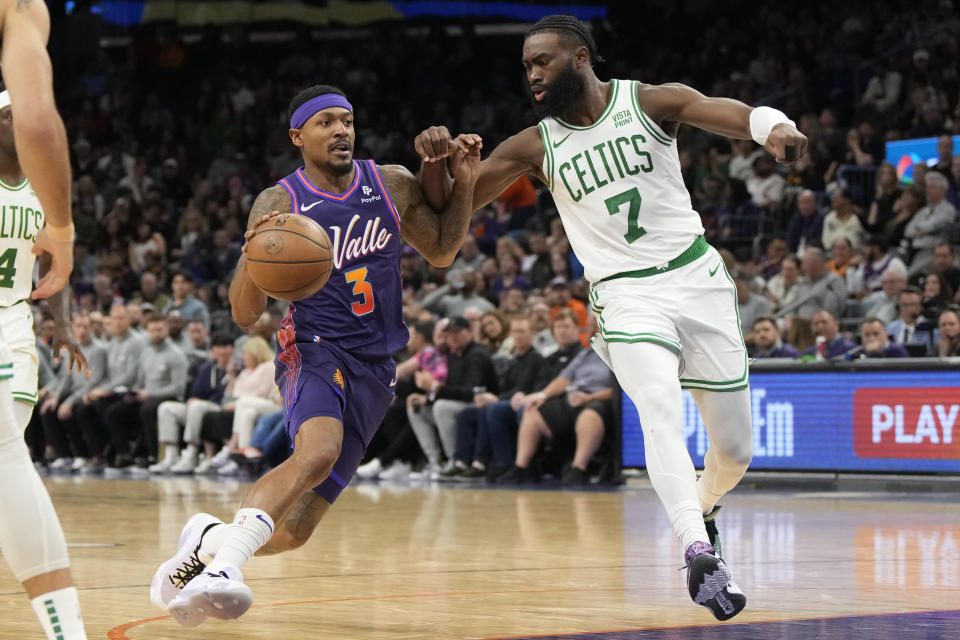 Phoenix Suns guard Bradley Beal (3) drives against Boston Celtics guard Jaylen Brown during the second half of an NBA basketball game, Saturday, March 9, 2024, in Phoenix. (AP Photo/Rick Scuteri)