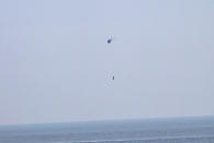 Franky Zapata, a 40-year-old inventor, takes to the air in Sangatte, Northern France, at the start of his attempt to cross the channel from France to England, aboard his flyboard, Sunday Aug. 4, 2019. Zapata will try again Sunday, to traverse the English Channel on a flying board after his first attempt failed when he crashed into a refueling boat 20 kilometers (12 miles) into the trip. (AP Photo/Michel Spingler)