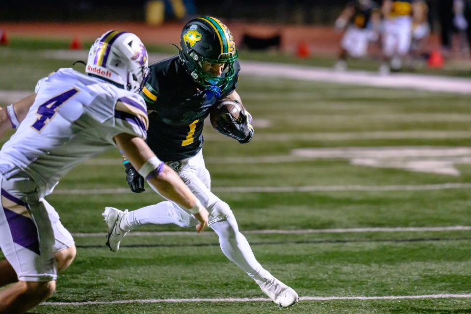 Rock Bridge's Drevyn Seamon (1) gets past Troy Buchanan's Talen Howland (4) during the Class 6 District 4 championship game at Rock Bridge High School on Nov. 10, 2023, in Columbia, Mo.