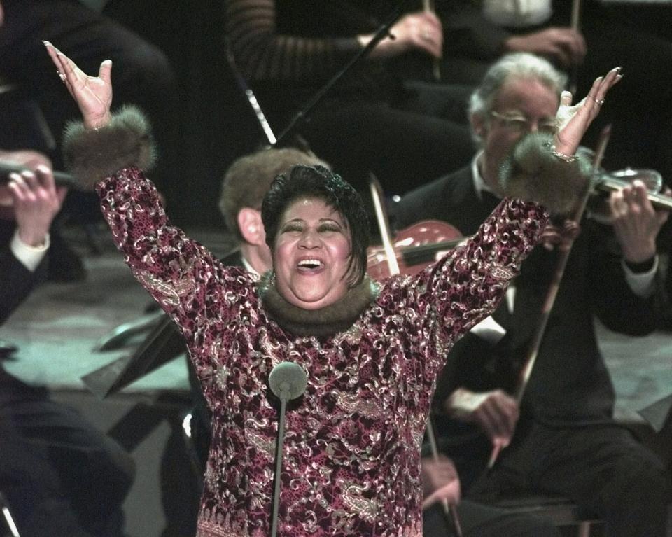 Aretha Franklin raises her arms in jubilation after standing in for Luciano Pavarotti at the last minute at the 40th annual Grammy Awards in February 1998, at Radio City Music Hall in New York.  Franklin sang "Nessun Dorma" from Puccini's "Turandot" after  Pavarotti called in sick.