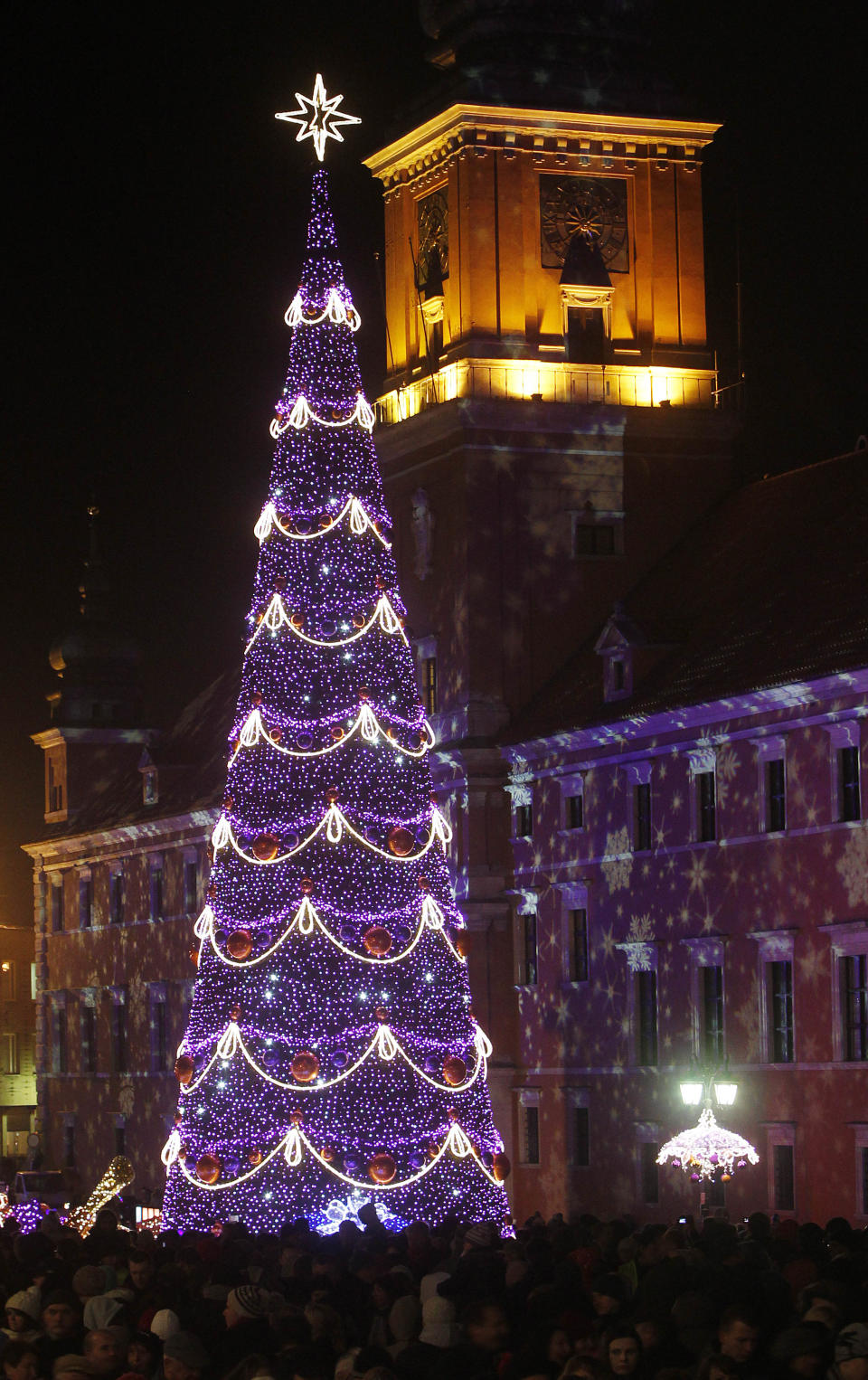 People enjoy the Christmas illuminations at the Royal Treaty street in Warsaw, Poland, Saturday, Dec. 1, 2012. (AP Photo/Czarek Sokolowski)