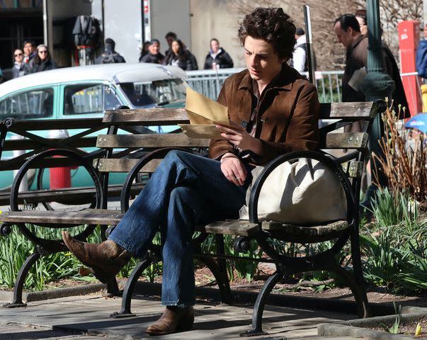 <p>Jose Perez/Bauer-Griffin/GC Images</p> Timothee Chalamet films a scene on a park bench for the Bob Dylan biopic 'A Complete Unknown'