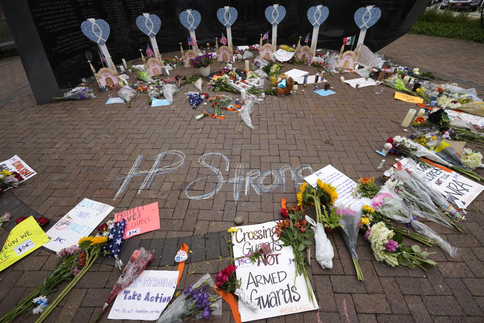 A memorial to the seven people killed and others injured in Monday's Fourth of July mass shooting grows at a veterans memorial Wednesday, July 6, 2022, in Highland Park, Ill. (AP Photo/Charles Rex Arbogast)