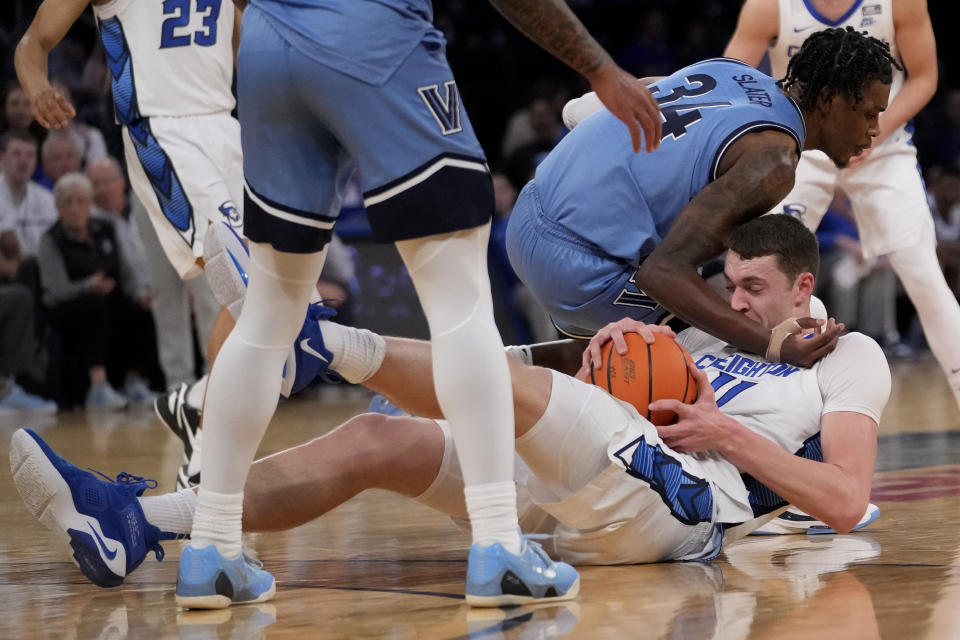 Creighton's Ryan Kalkbrenner, center, and Villanova's Brandon Slater, right, battle for the ball in the first half of an NCAA college basketball game during the quarterfinals of the Big East conference tournament, Thursday, March 9, 2023, in New York. (AP Photo/John Minchillo)