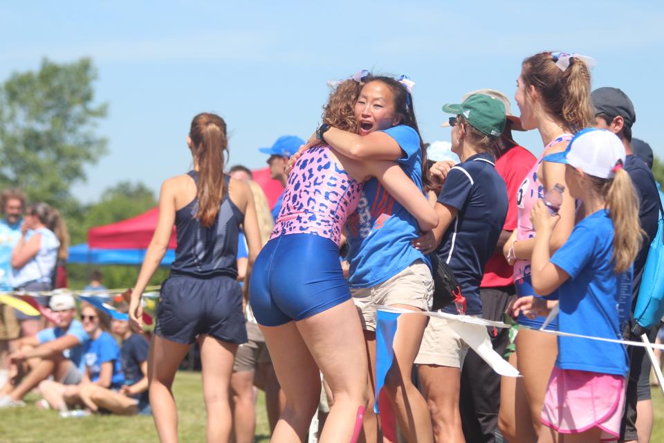 Saugatuck coach Angelina Bauer hugs Johnson after her personal best jump