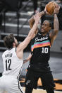 San Antonio Spurs' DeMar DeRozan (10) looks to pass as he is defended by Brooklyn Nets' Joe Harris during the first half of an NBA basketball game, Monday, March 1, 2021, in San Antonio. (AP Photo/Darren Abate)